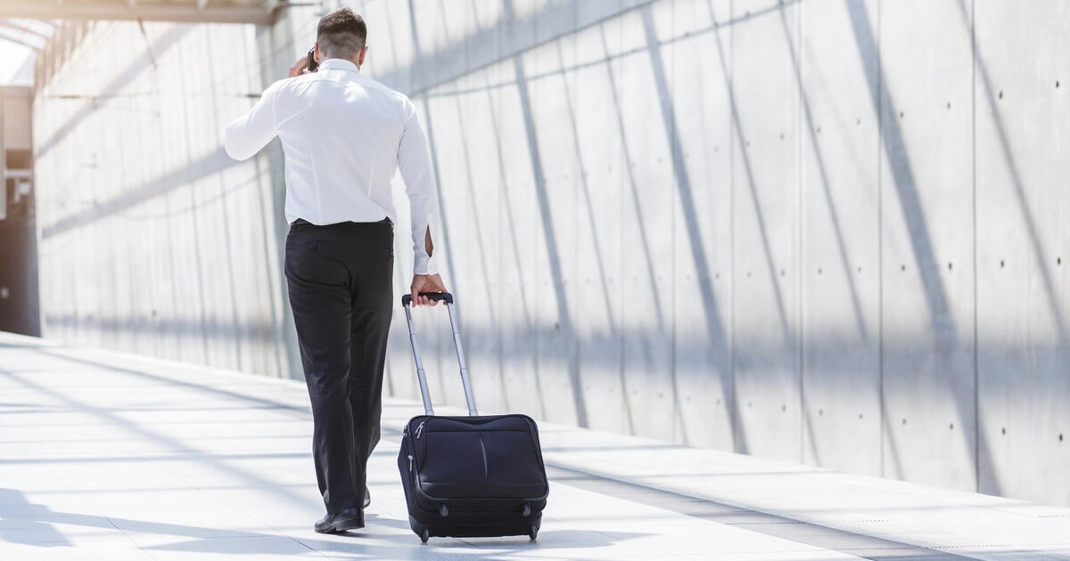 Businessman at airport with travel bag. Photo: Royalty Free via Getty