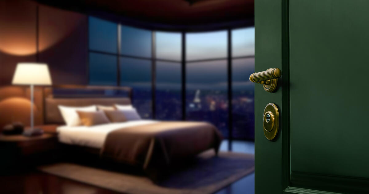 Slightly open door of luxury hotel room or apartment with blur interior background