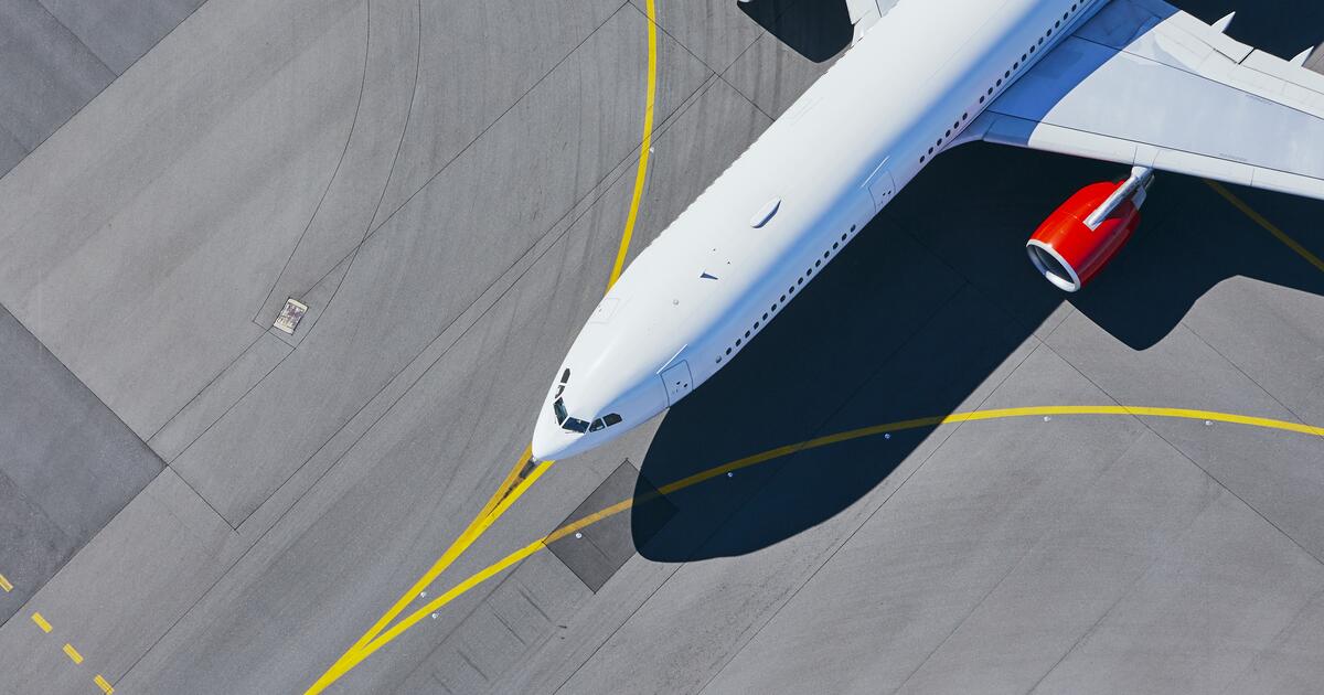 Aerial view of airport. Airplane taxiing to runway before take off. Photo: iStock