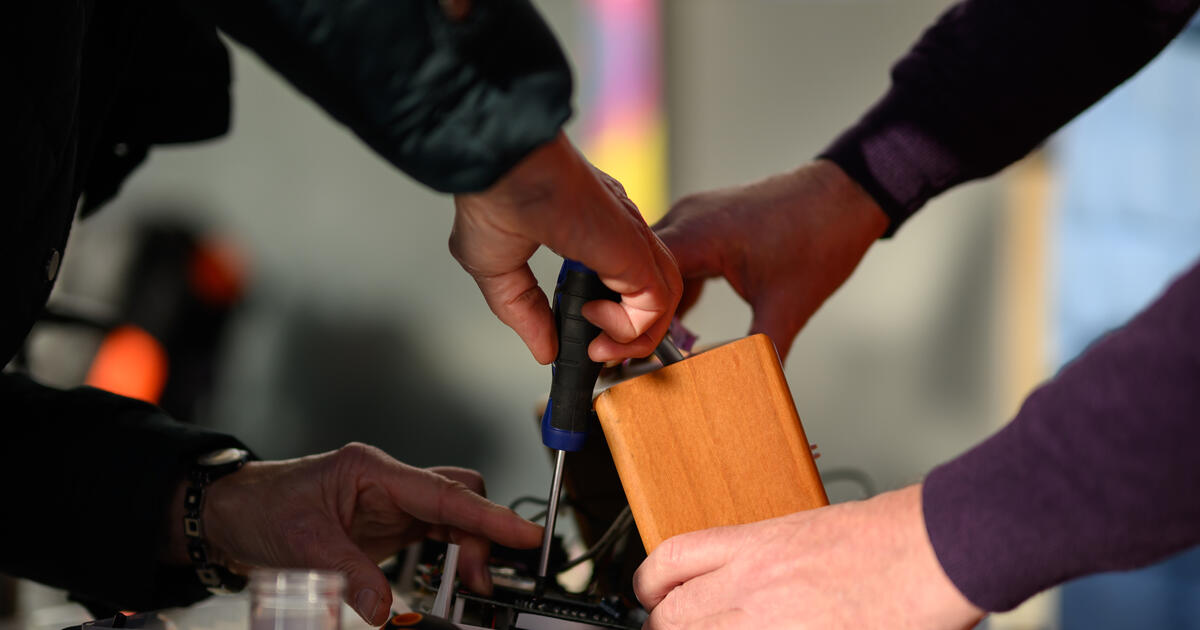 Project Manager Dermot Jones and Anne Flynn reassemble her broken DAB radio