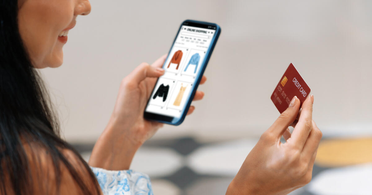 Young woman using smarpthone with credit card