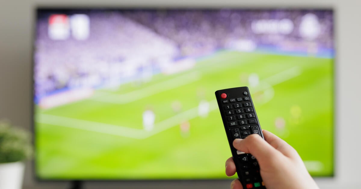Smart TV showing football plus remote