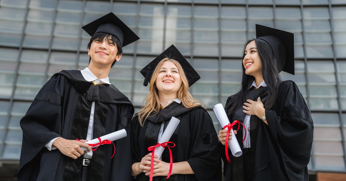 Three international student graduates_Digital - SEOSocialEditorial image