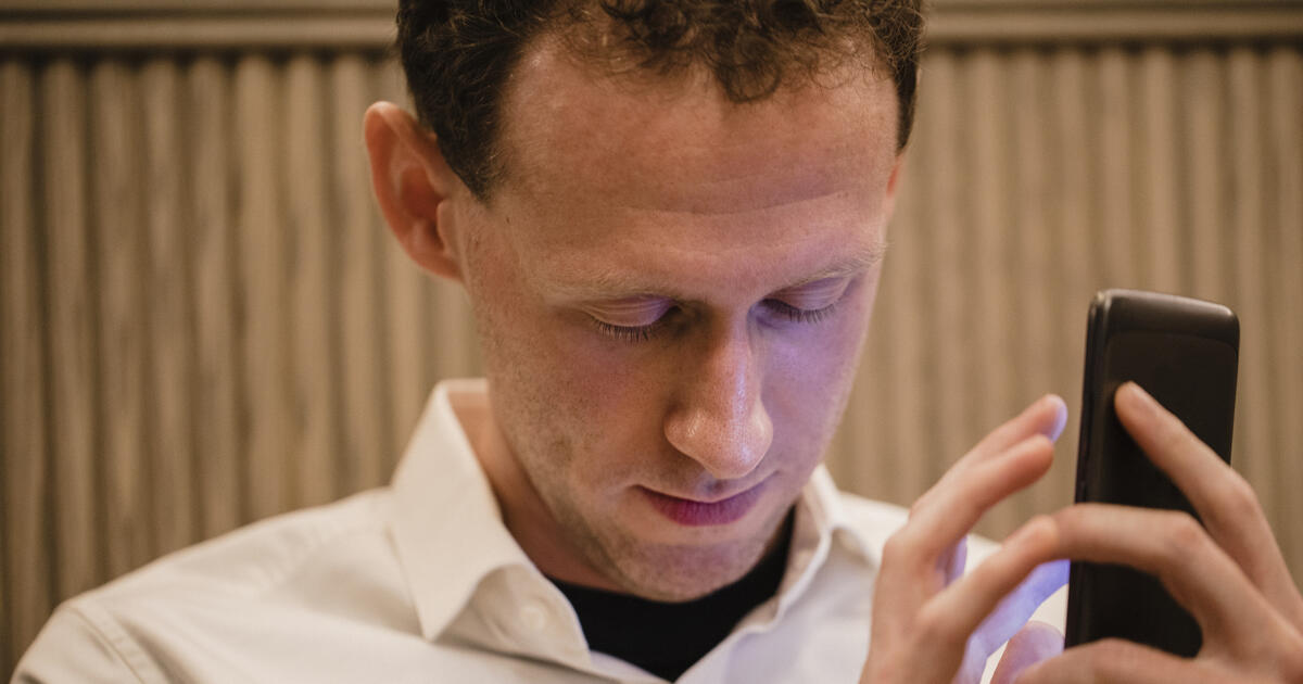 Visually impaired man using mobile device