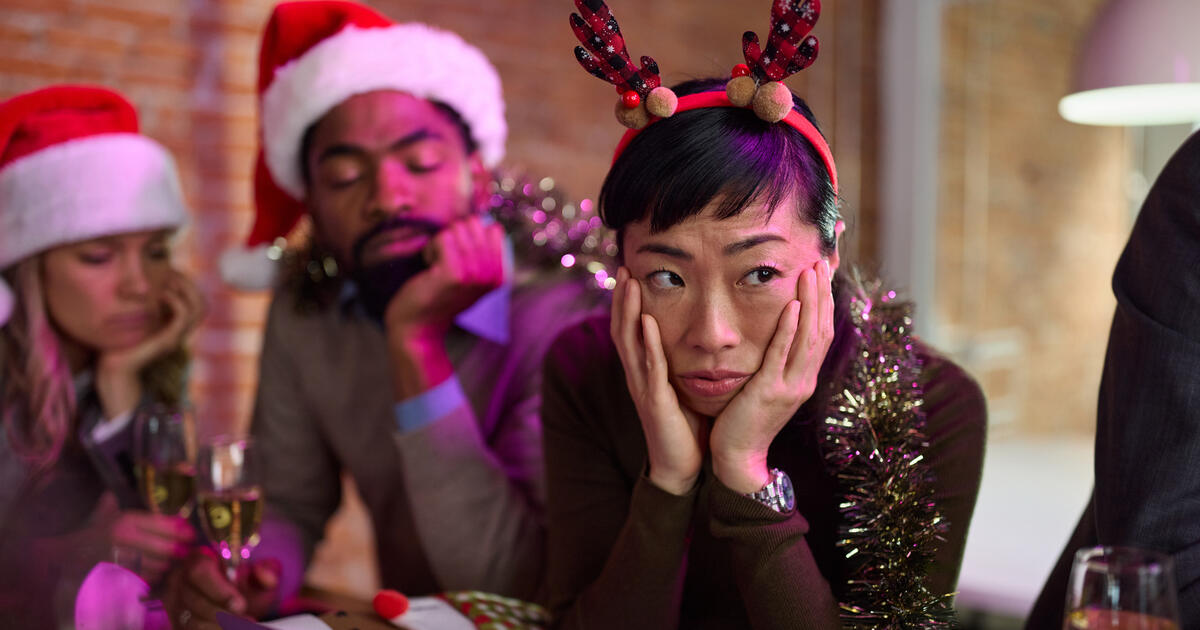Employees looking disgruntled at an office Christmas party