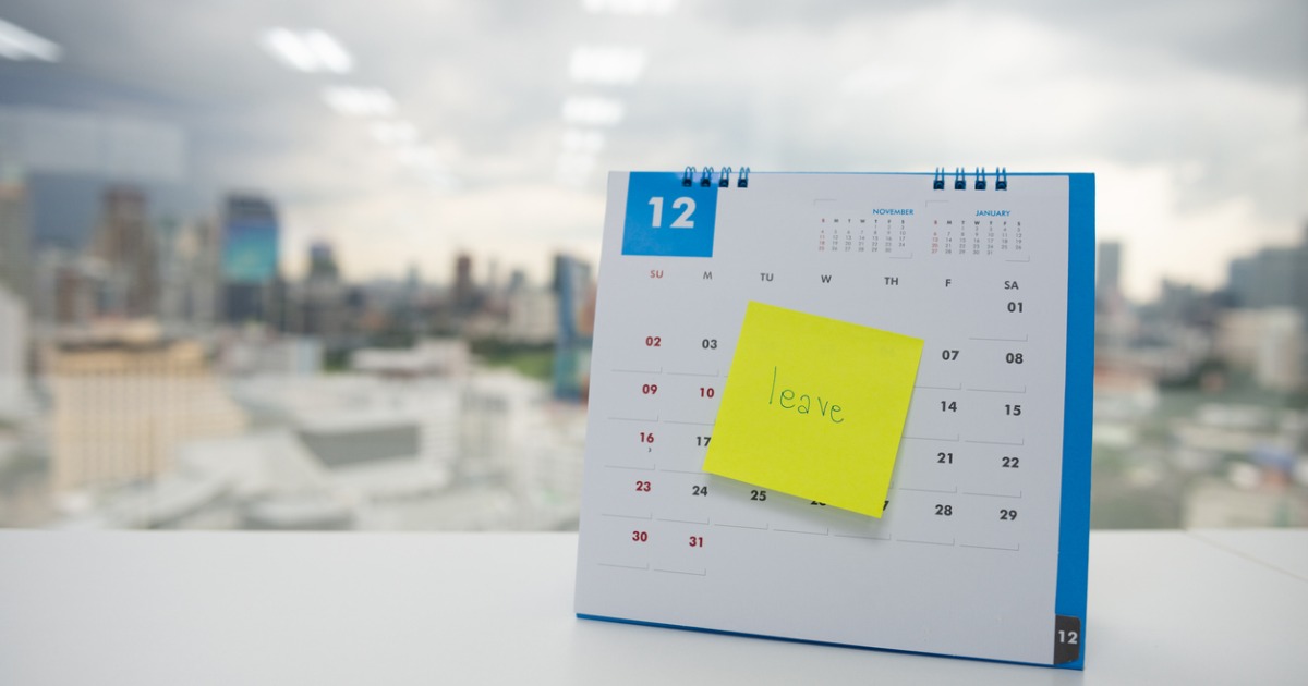 leave on paper note stuck to calendar editorial