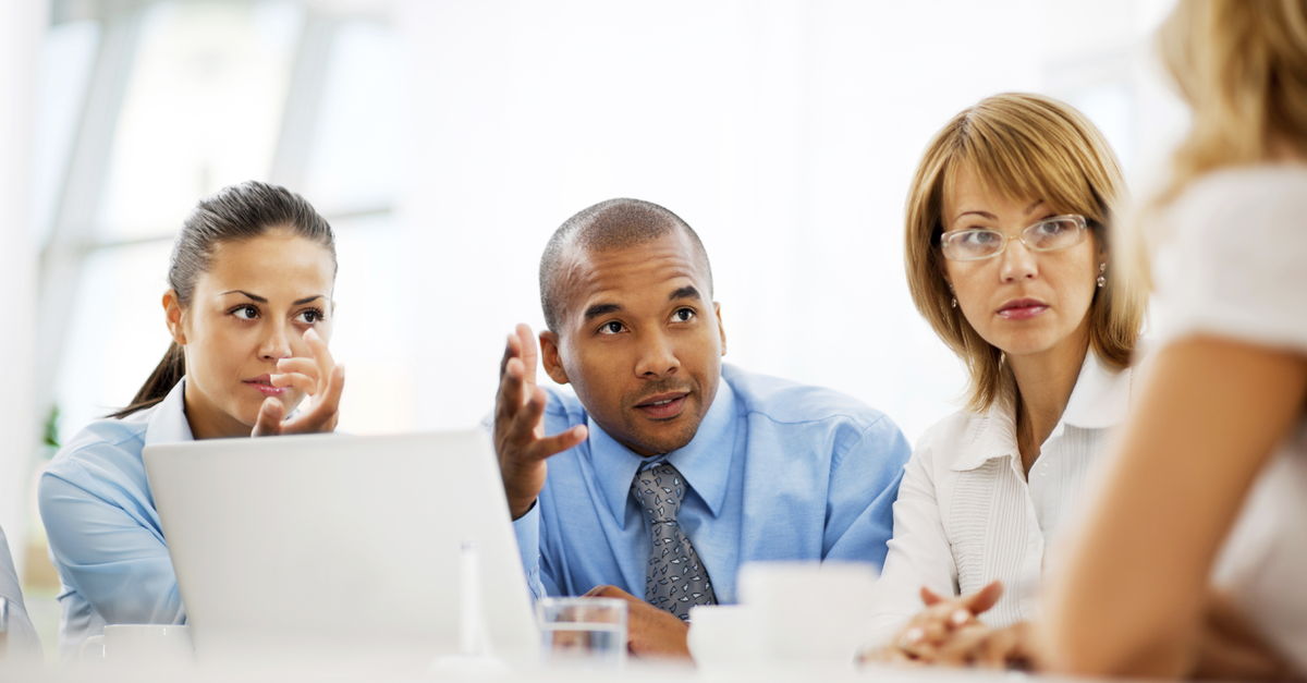 Smiling group of businesspeople working at laptop-LinkedIn