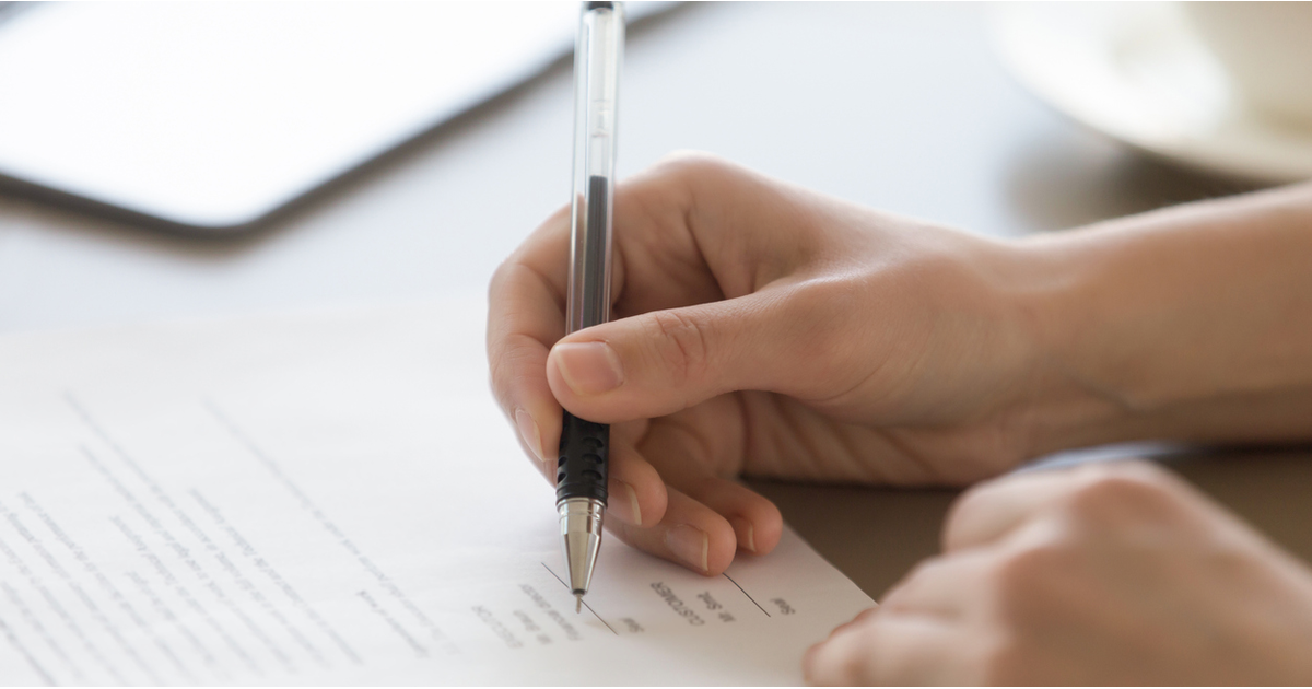 Hand signing legal document regulatory approval-LinkedIn