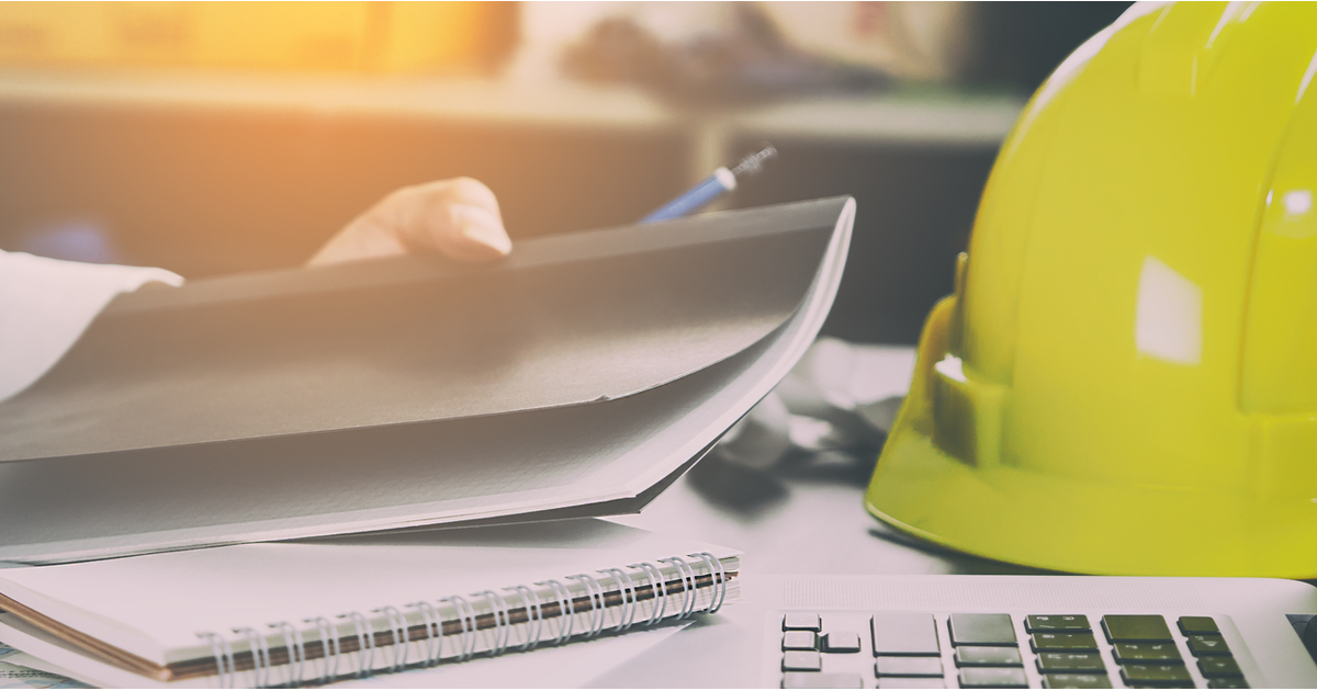 Hard hat at a desk construction contractor disputes