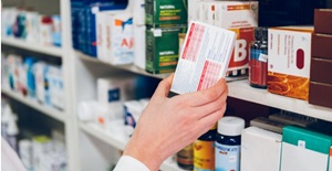 a-young-woman-pharmacist-arranges-medicines-on-the-shelves-of-the-pharmacy card