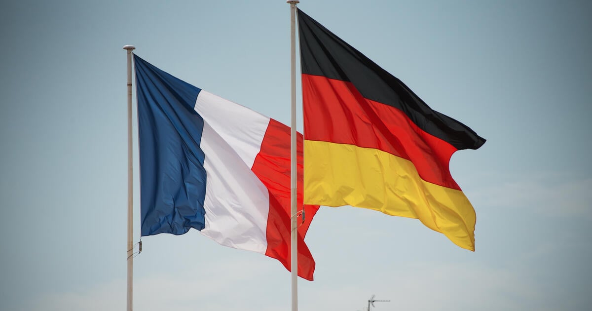 The flags of Germany and France flying from flag poles