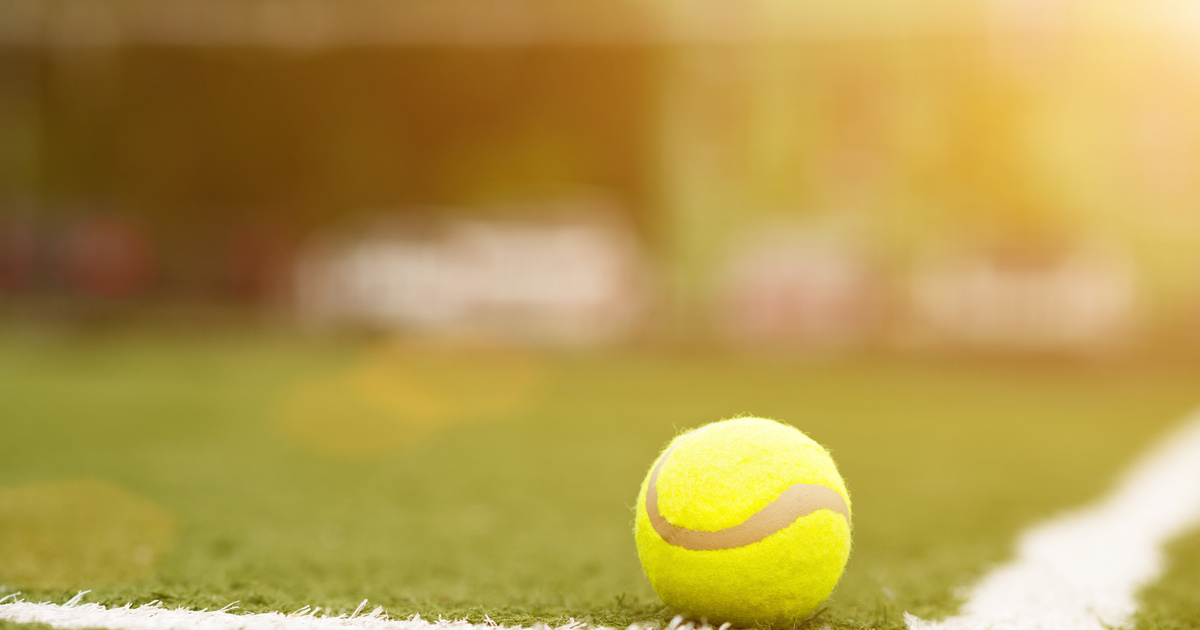 Tennis ball on grass court SEO