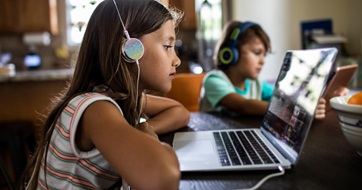 Young siblings on devices SEO